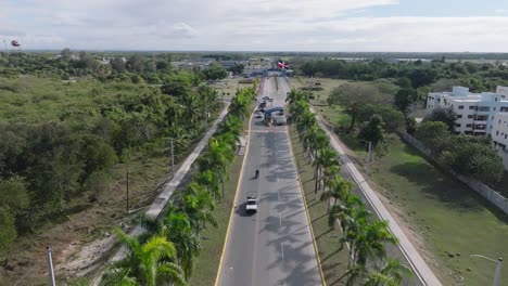 Aerial-flyover-palm-tree-road-to-entrance-of-SAN-ISIDRO-Air-Base-with-checkpoint-in-Dominica-Republic