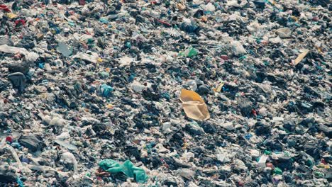 Close-up-of-an-open-air-plastic-heap,-lots-of-blue-bags