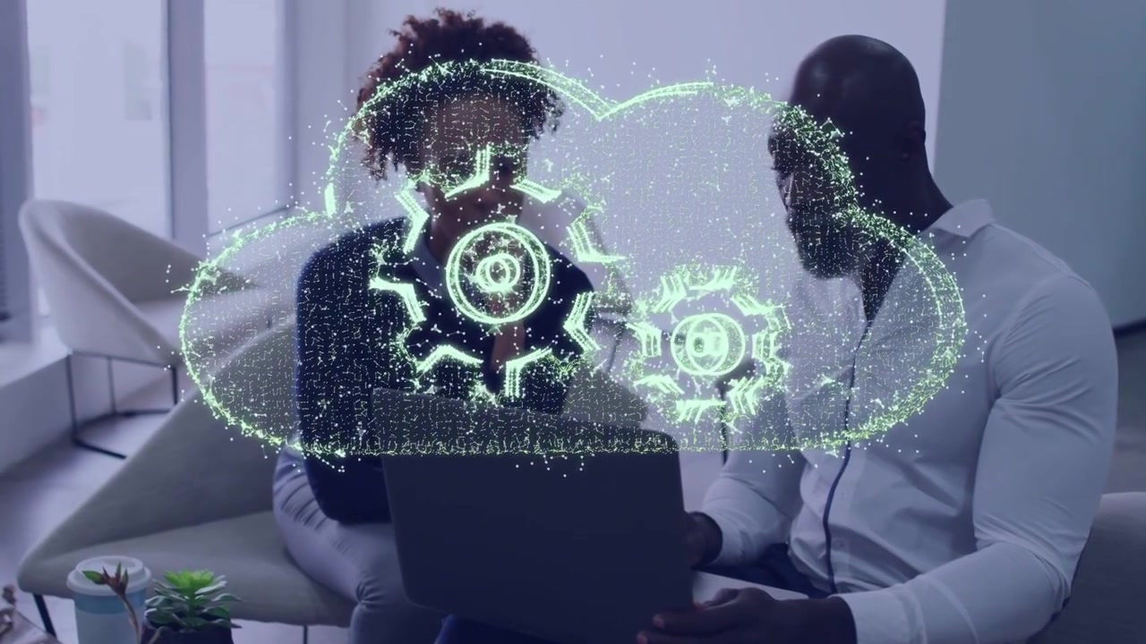 Team viewing laptop, green streak starting then expanding into gear cloud hologram showing workflow