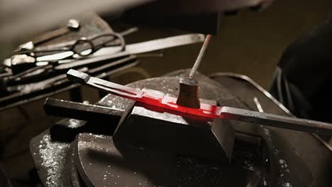 blacksmith working on a metal piece