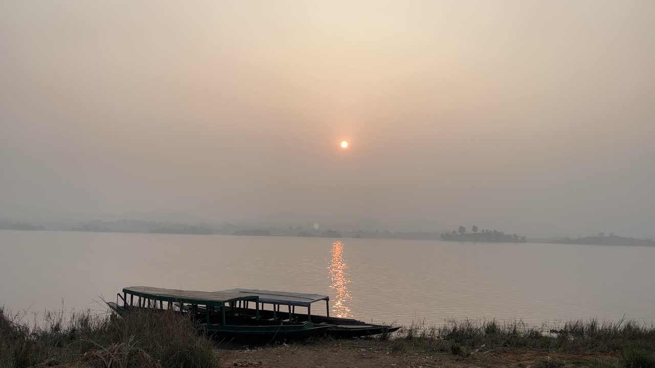 The sun is setting over the lake.