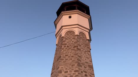 Tilt-up-on-Sahat-Tepe-clock-tower-at-sunset,-Plovdiv,-Bulgaria