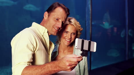 happy couple using selfie stick