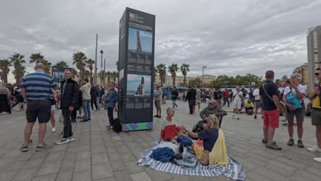 crowds gather in barceloneta, barcelona for a sailing event