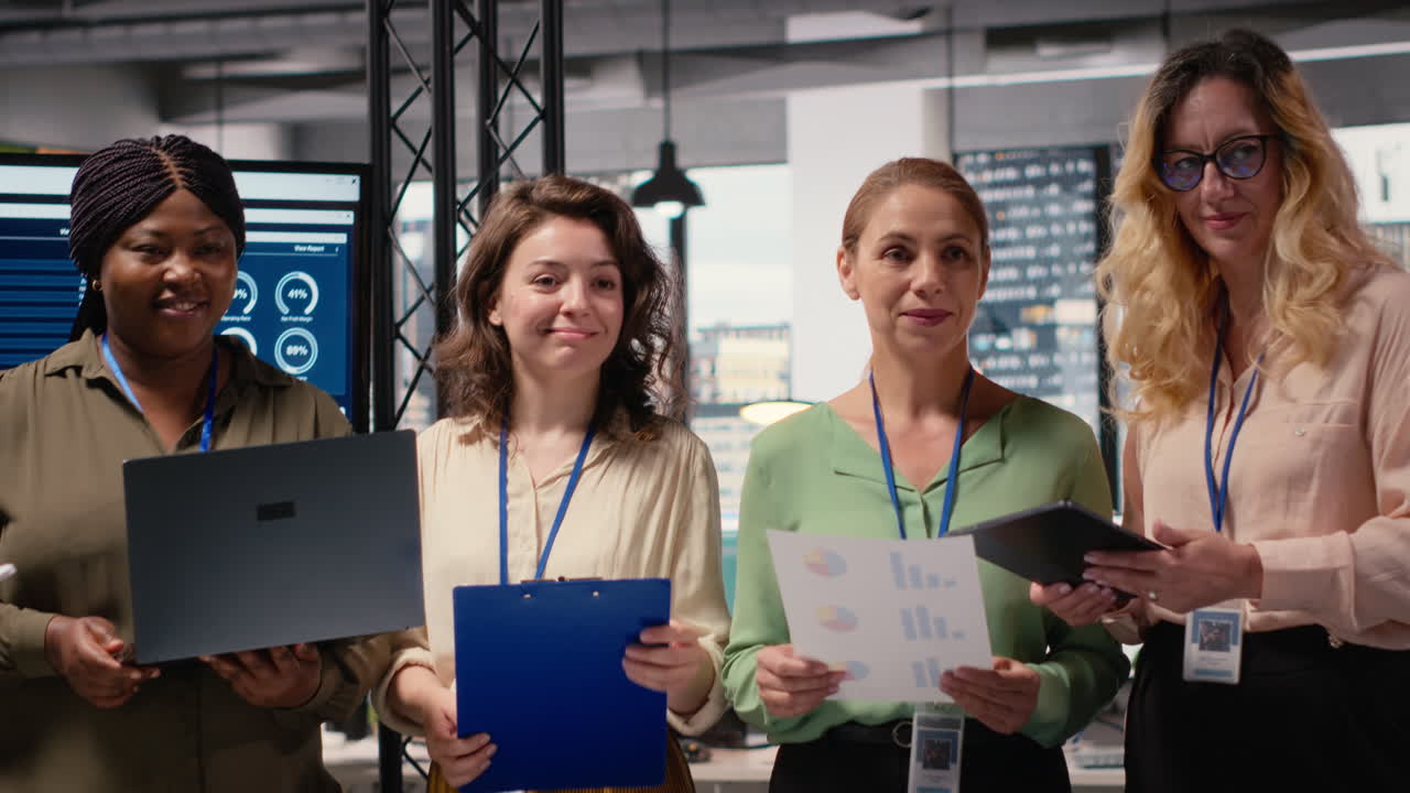 Portrait of diverse group of businesswomen collaborating on report writing