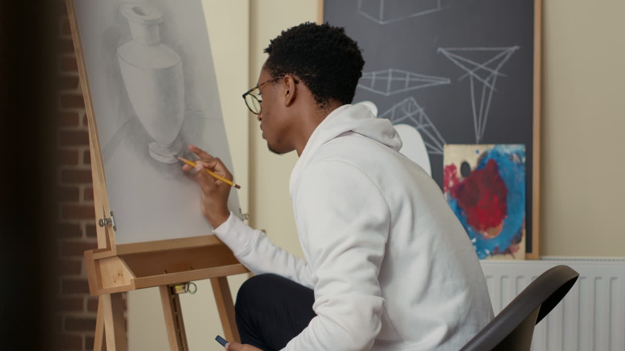 African american student using smartphone to take picture of drawing