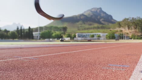 Disabled-mixed-race-man-with-prosthetic-legs-running-on-race-track