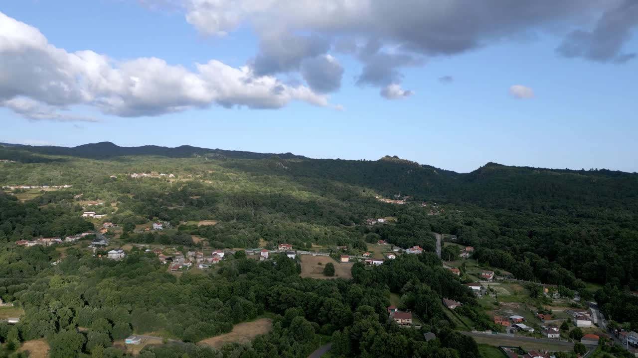tranquila ciudad de ladera con nubes por encima proyectando sombras en el montañoso campo español