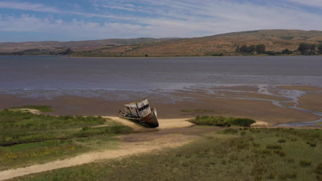 drone flying by old shipwreck in point reyes near inverness, california, day time