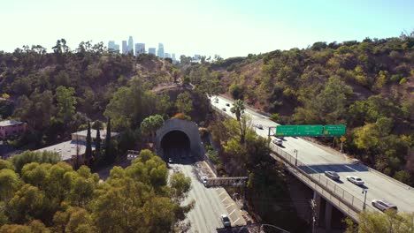 aerial freeway cars travel along the 110 freeway in los angeles through tunnels and towards downtown skyline 1