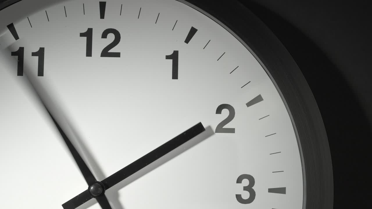 Clock Face in Time Lapse on Dark Grey Wall