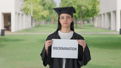 sad indian college graduate girl holding discrimination banner