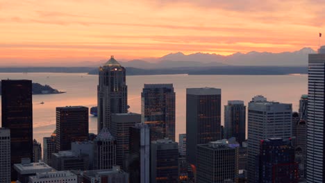 helicopter filming seattle skyline and mountain sunset background