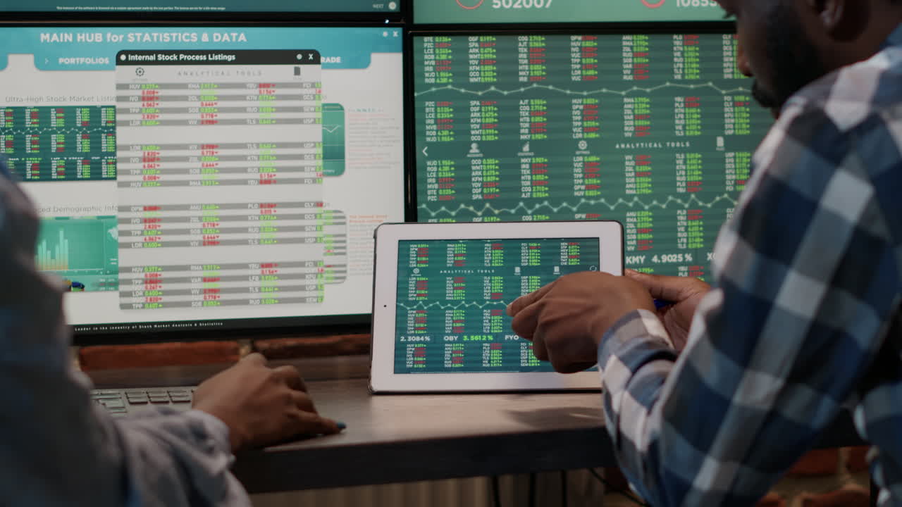 Brokers team using tablet to analyze forex exchange numbers