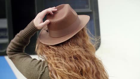 Rear-view-of-young-woman-waiting-for-the-train-outdoors