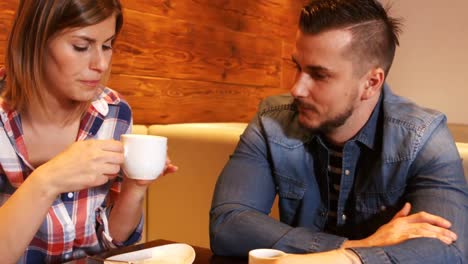 couple interacting while having a cup of coffee