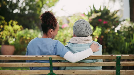 caregiver and senior woman on bench