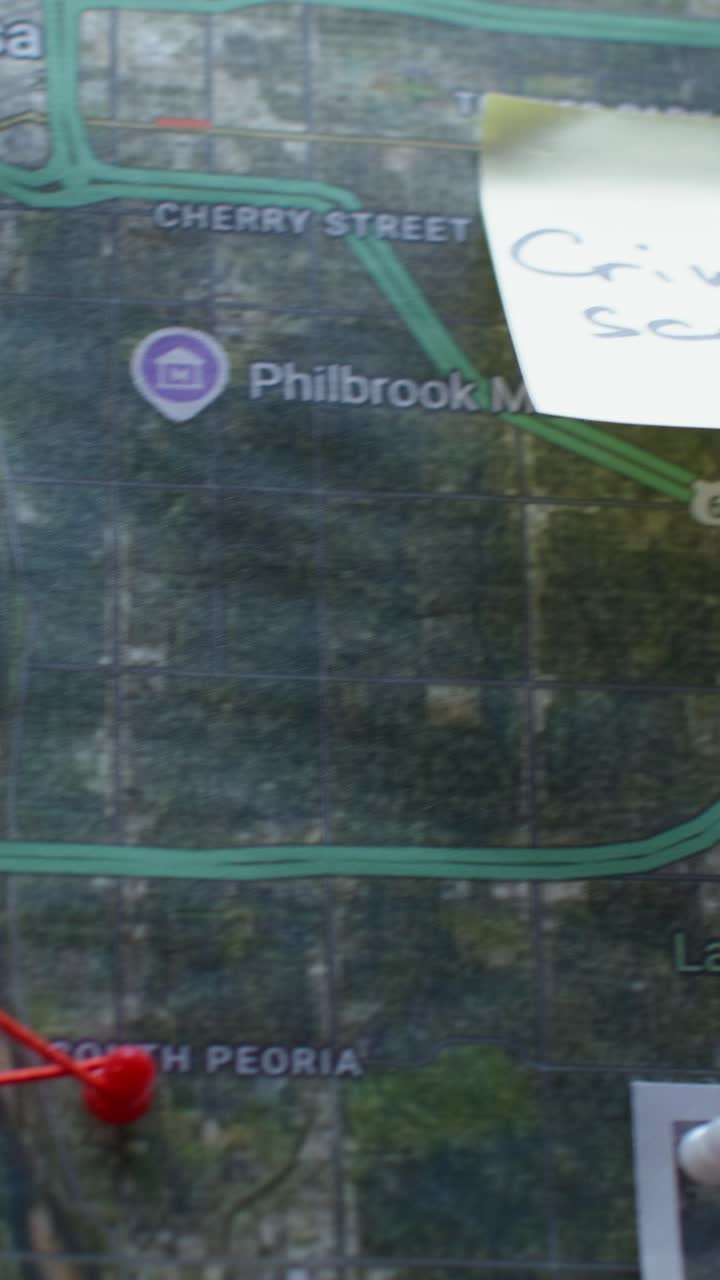 Person Marking Location on Map with Markers
