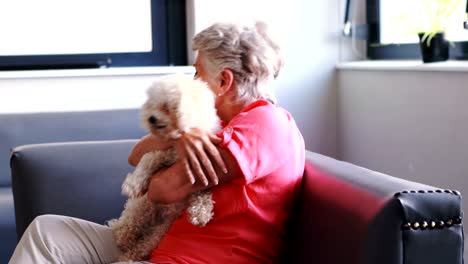 senior woman pampering dog