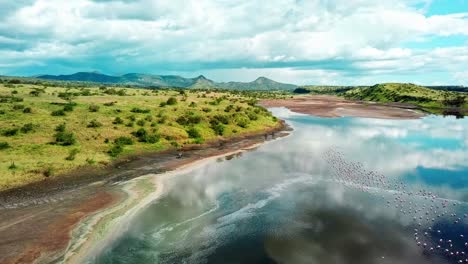 riding motorbikes alongside the stunning and picturesque view of lake magadi in kenya, africa- kenyan rift valley. drone-forward shot