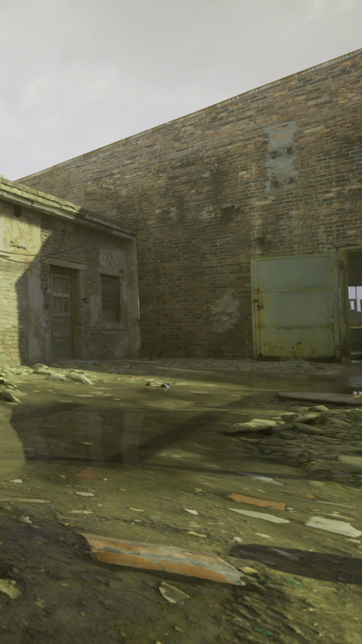 Old building and wet ground in a rundown area during the day