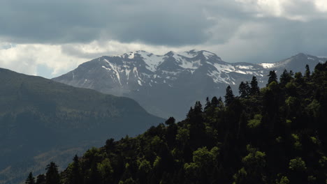 Timelapse-of-snowy-Mountain-Peak-covered-in-clouds-moving-Day-Koziakas-Greece-zooming-in