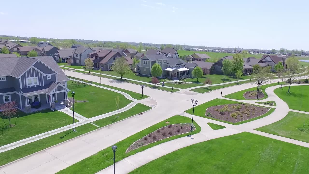 Drone video of a suburban neighborhood and street with kids playing