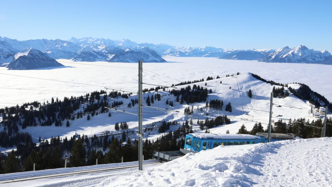 Train descending down the mountain in the winter, Rigi Switzerland establisher