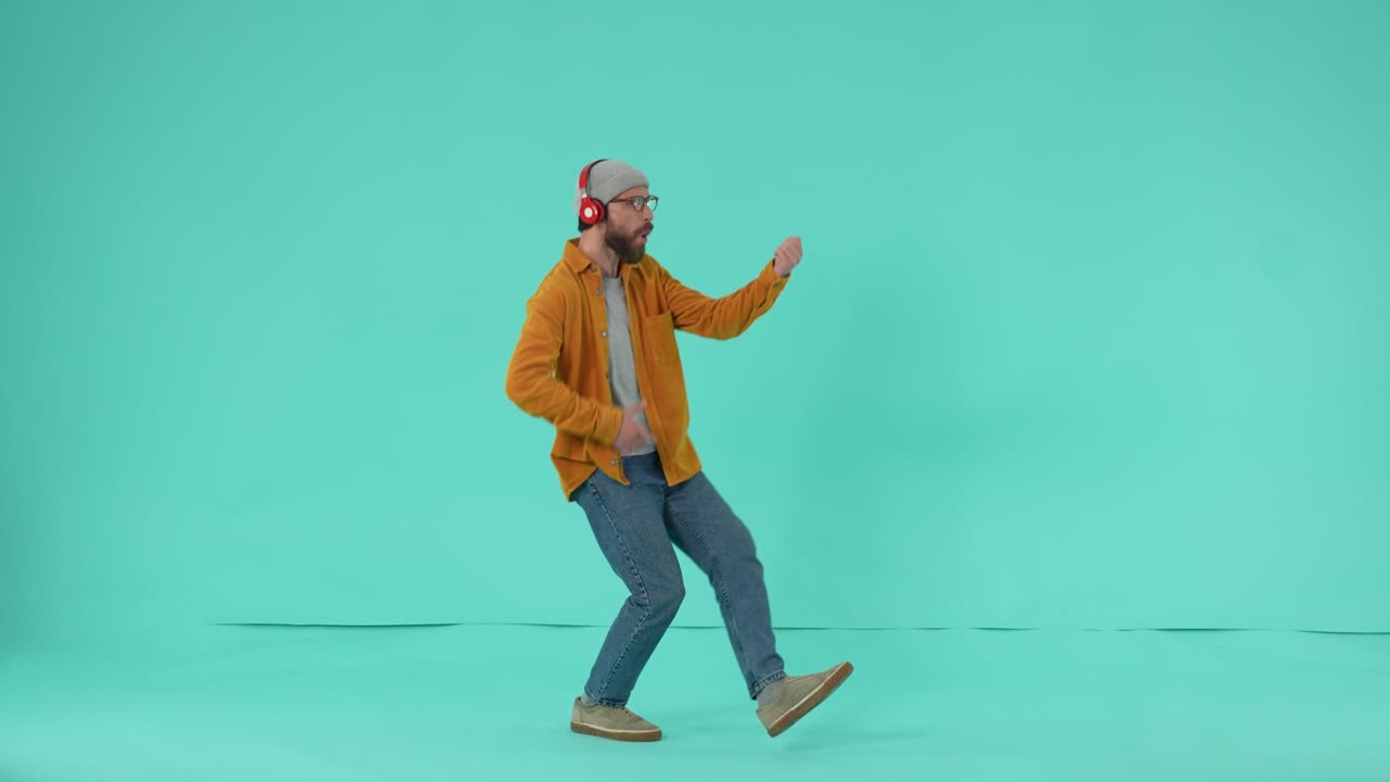 Joyful man dancing with imaginary bass guitar