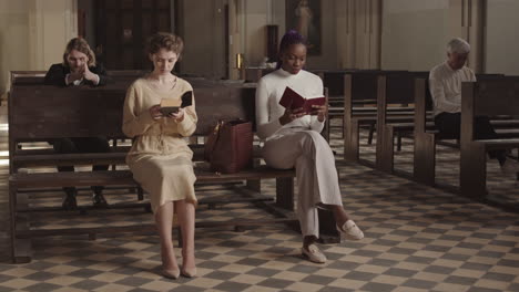 several diverse parishioners sitting in christian church