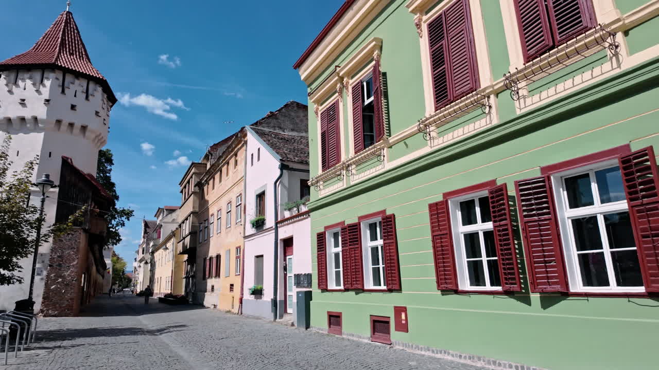 Charming Sibiu street with Turnul Olarilor, sunny day, calm ambiance