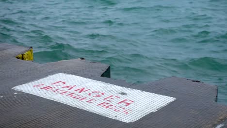 danger sign by choppy water