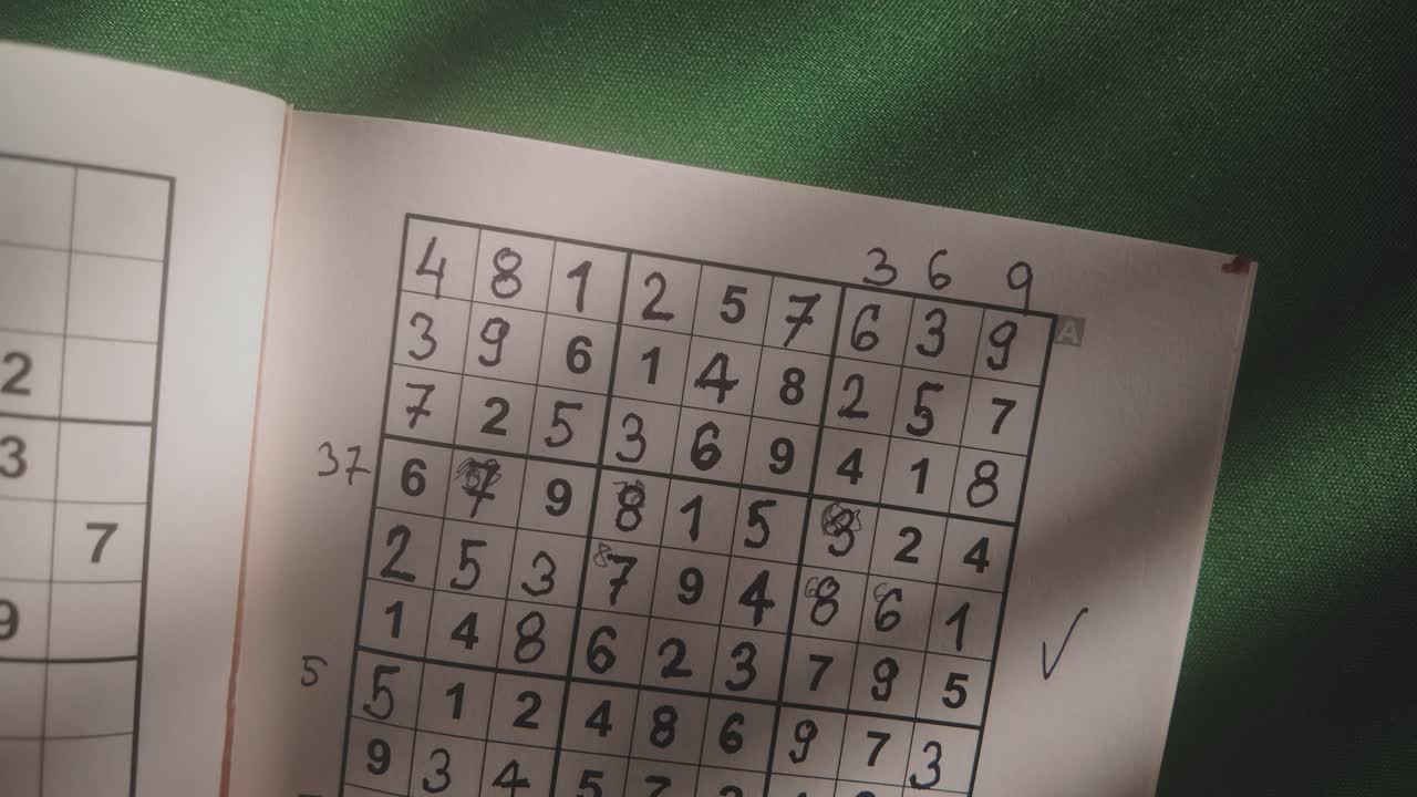 Solved Suduku numbers puzzle revealed in dimly lit study TOP DOWN shot