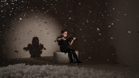 young girl playing violin in a winter scene