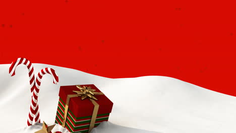animación de nieve cayendo sobre los bastones de caramelo y el regalo de navidad