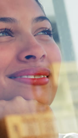 smiling woman looking out office window