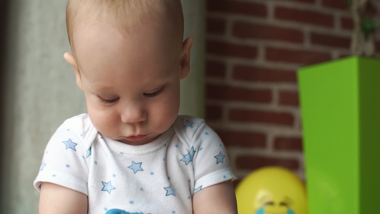 Cute baby near brick wall