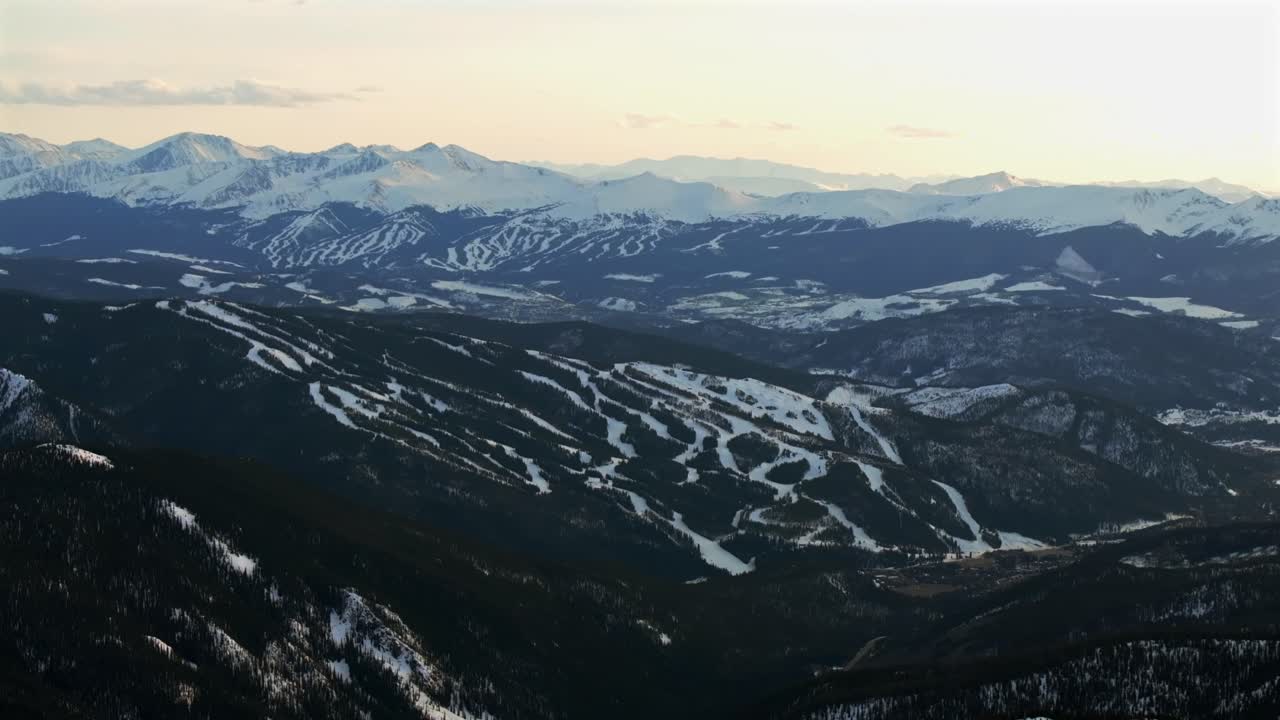 Winter Spring Keystone Breckenridge Ski Resort sunset golden hour Loveland Pass Colorado aerial drone Continental Divide Rocky Mountains ski trail runs Quandary Peak Boreas Pass forward pan up motion