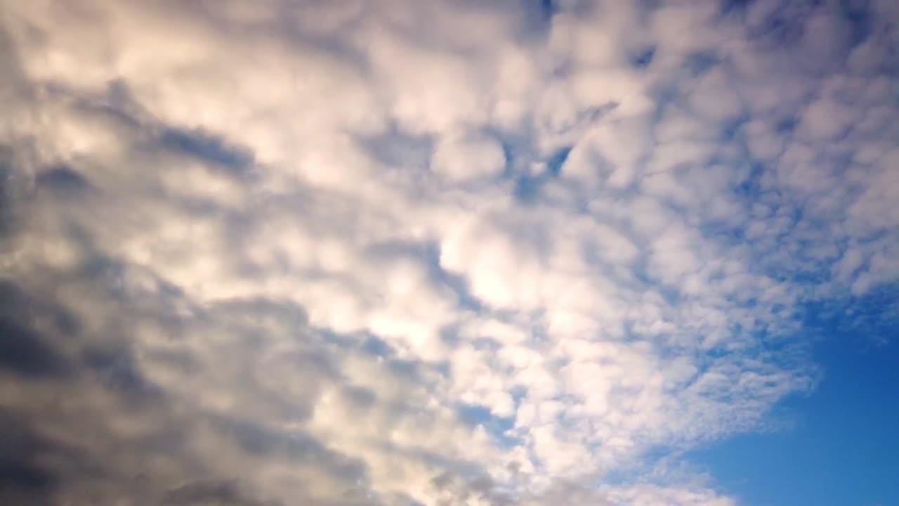 Amazing multi layered dark cloud building up timelapse with blue sky in the background before the storm