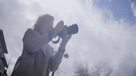 woman taking pictures in the city