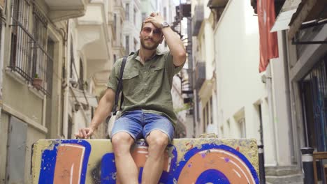 young man sitting to rest in the city center.