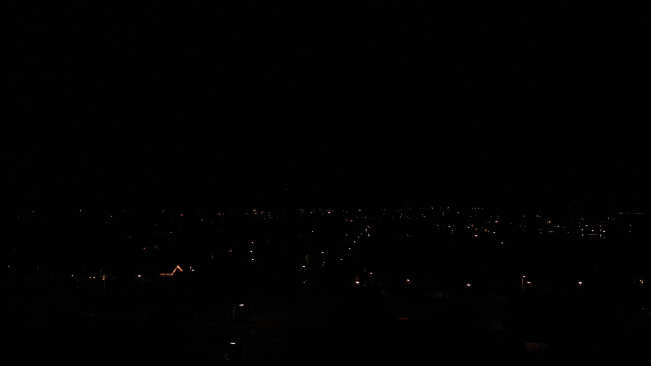 도시 풍경 위의 어두운 저녁 하늘에 불이 터지고 있다