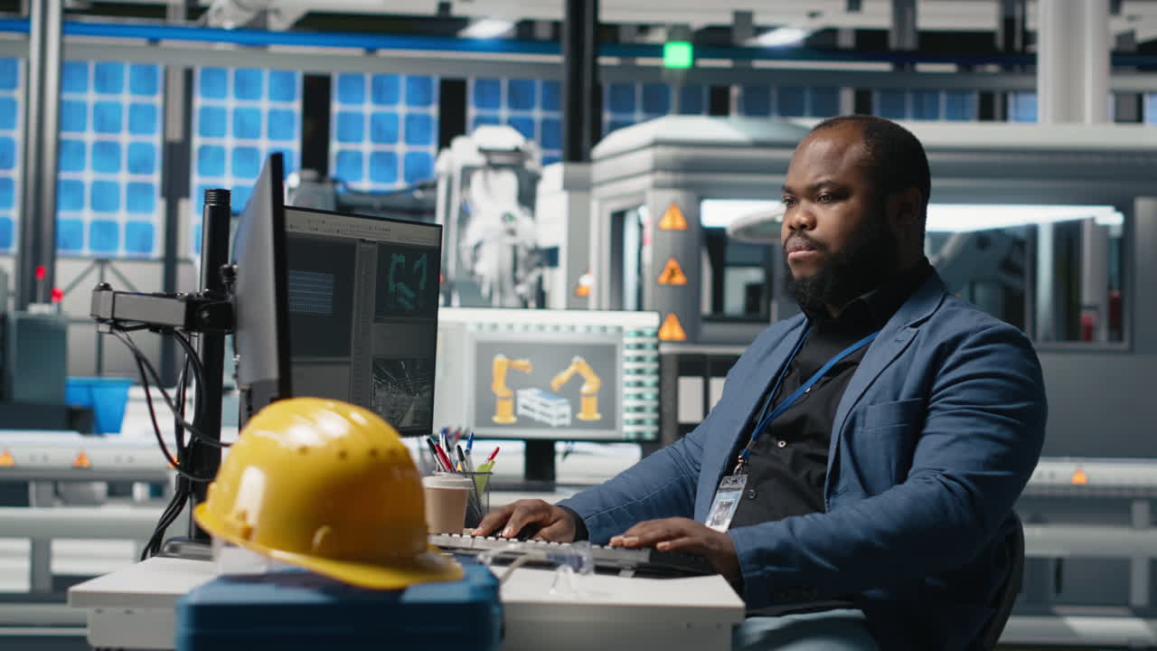 Engineer Working on Robotic Automation in Factory