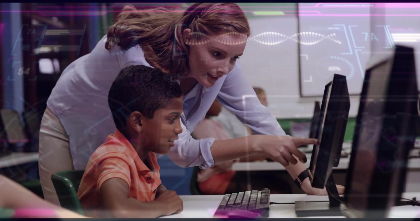 Vertical video: Guiding teacher walking and pointing at screen in lab, boy in orange polo typing