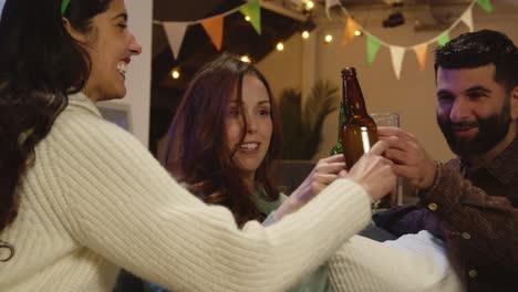 Group-Of-Friends-At-Home-Or-In-Bar-Dressing-Up-Celebrating-At-St-Patrick's-Day-Party-Drinking-Alcohol-And-Doing-Cheers