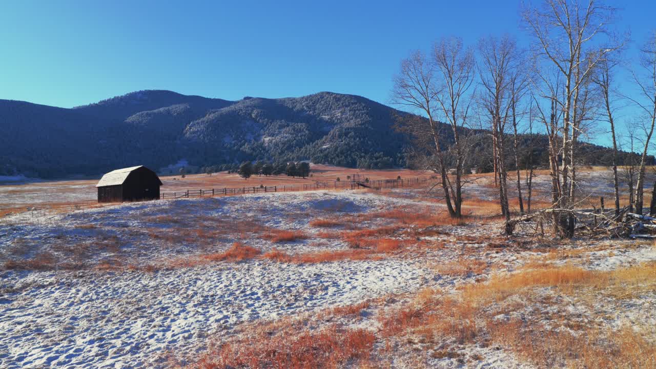 Bergren Peak Elk Meadow Park rød ladebygning åbent område vandresti solrig solnedgang Evergreen Colorado dronebillede blå himmel sneklædte forbjerge dal skov Front Range Rocky Mountains opadgående panorering