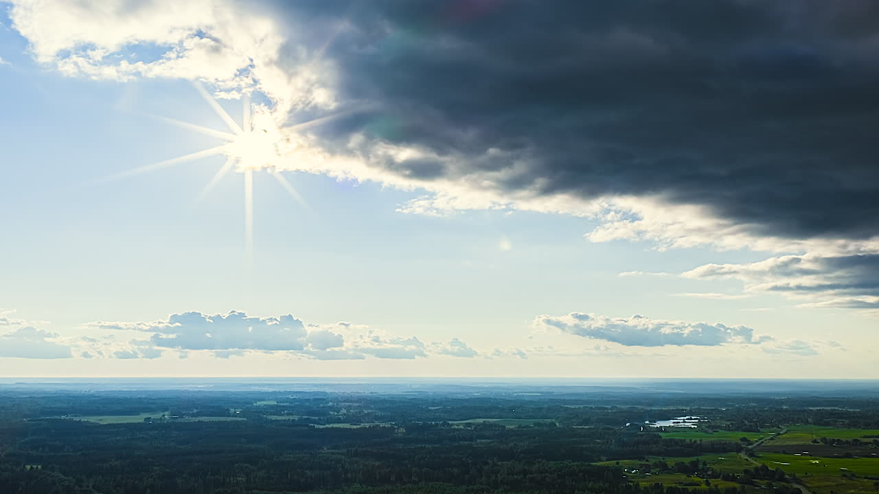 Sunny day over green fields with some clouds, peaceful landscape view