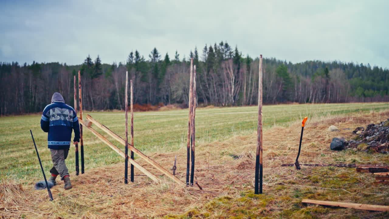 Timelapse Of A Man Building A Traditional Skigard Wooden Fence In The Norwegian Farm