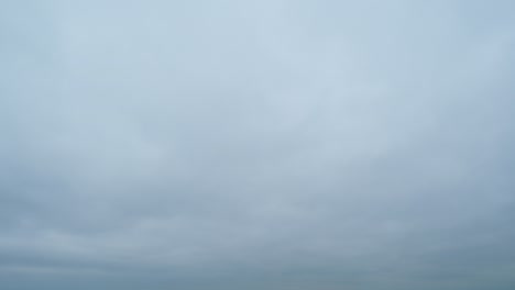 storm clouds moving across dark gray sky background. time lapse.