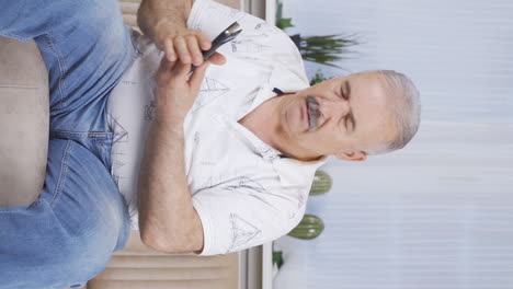 Vertical-video-of-The-old-man-who-got-bad-news-on-the-phone.